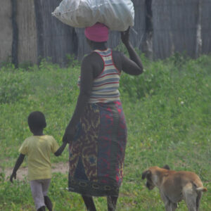 woman with huge bag on her head walking in balance