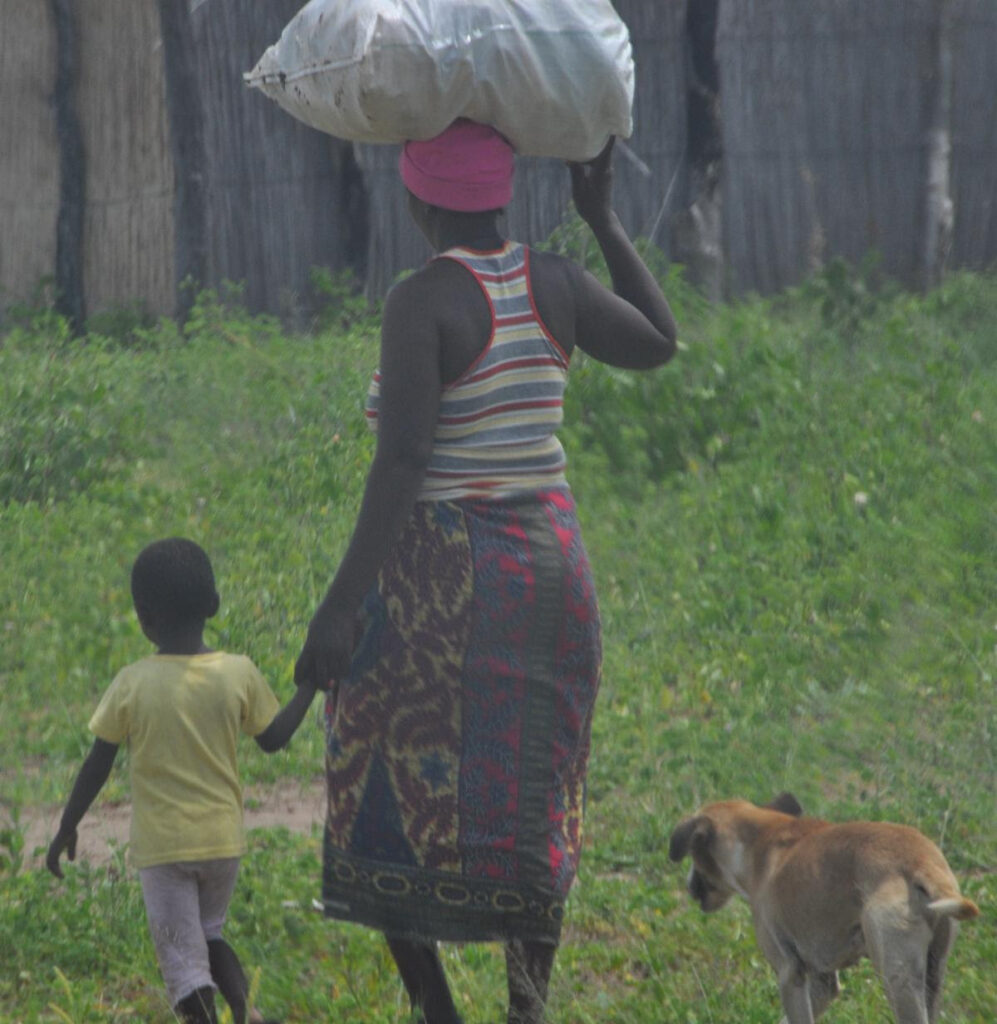 woman with huge bag on her head walking in balance