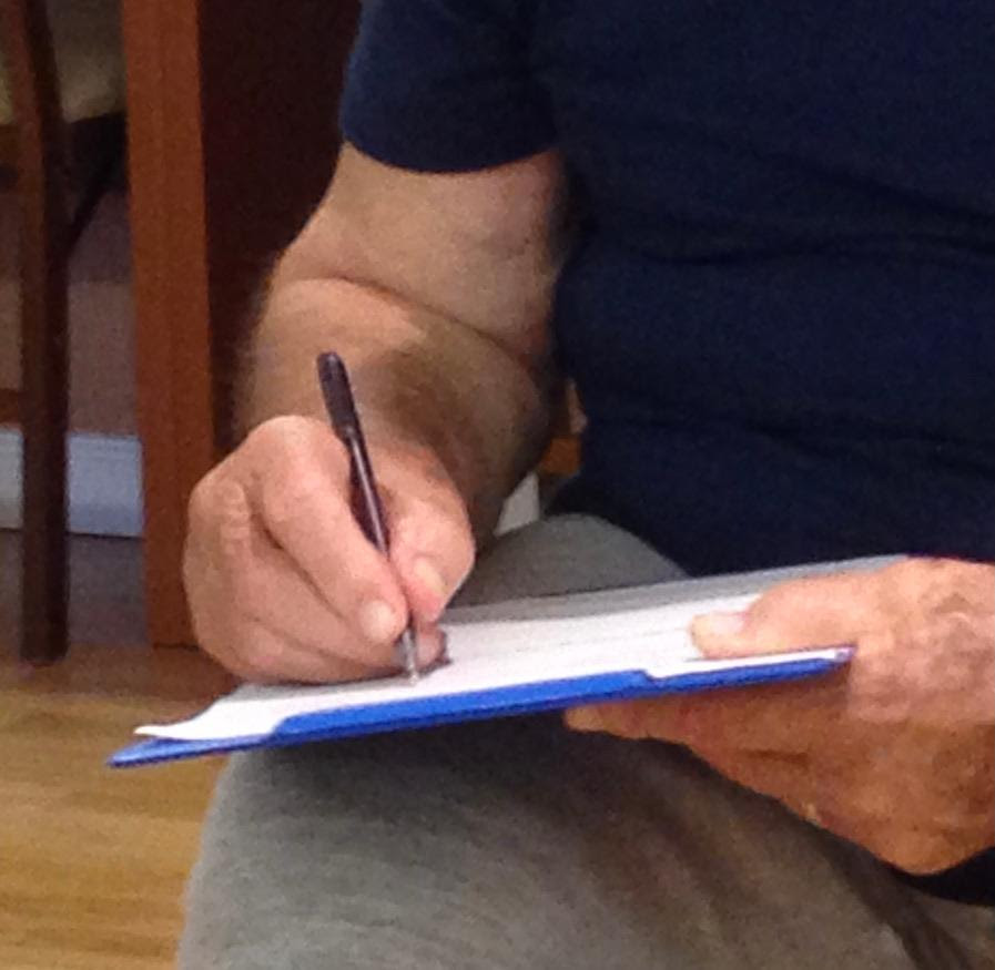 guy writing on clipboard