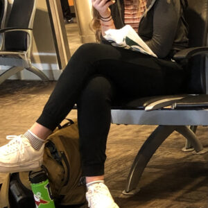 Woman reading folding her knees