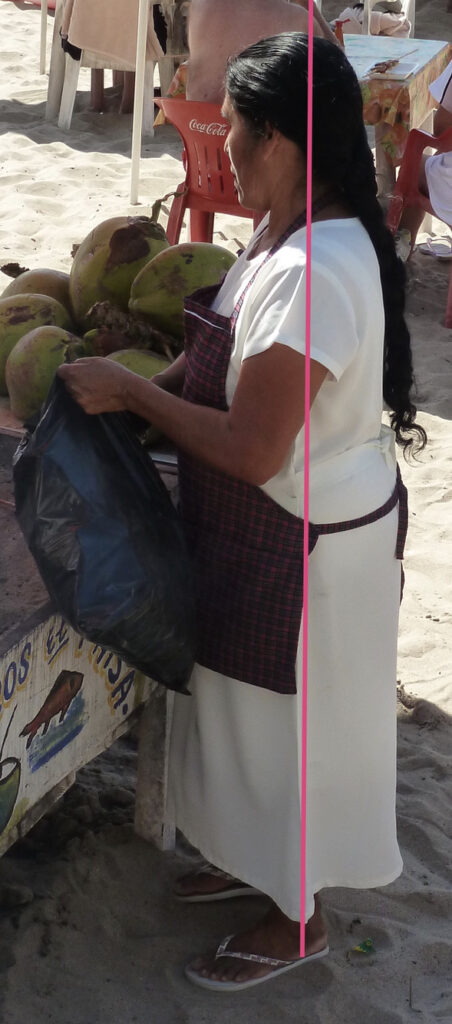 Woman standing selling watermelons