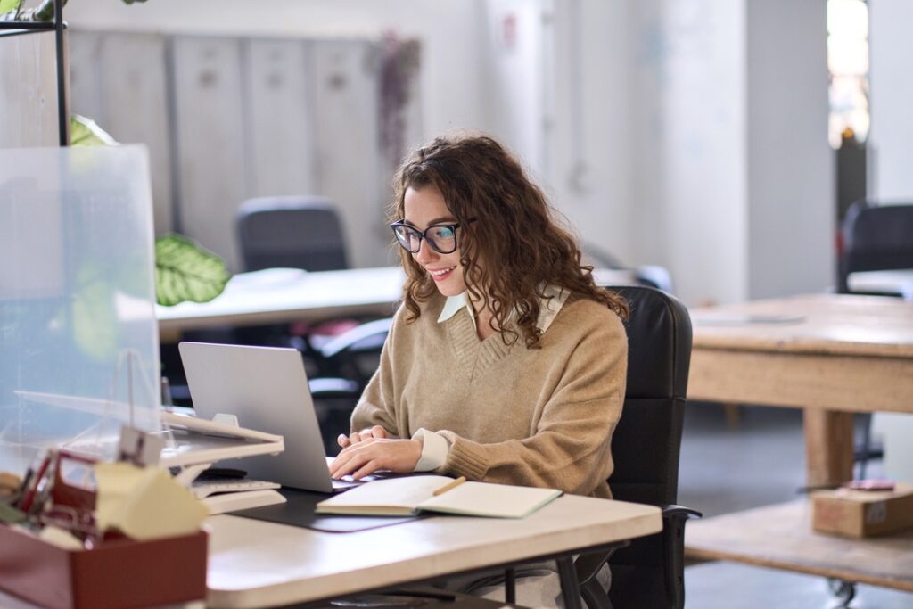 Young happy professional business typing on keyboard