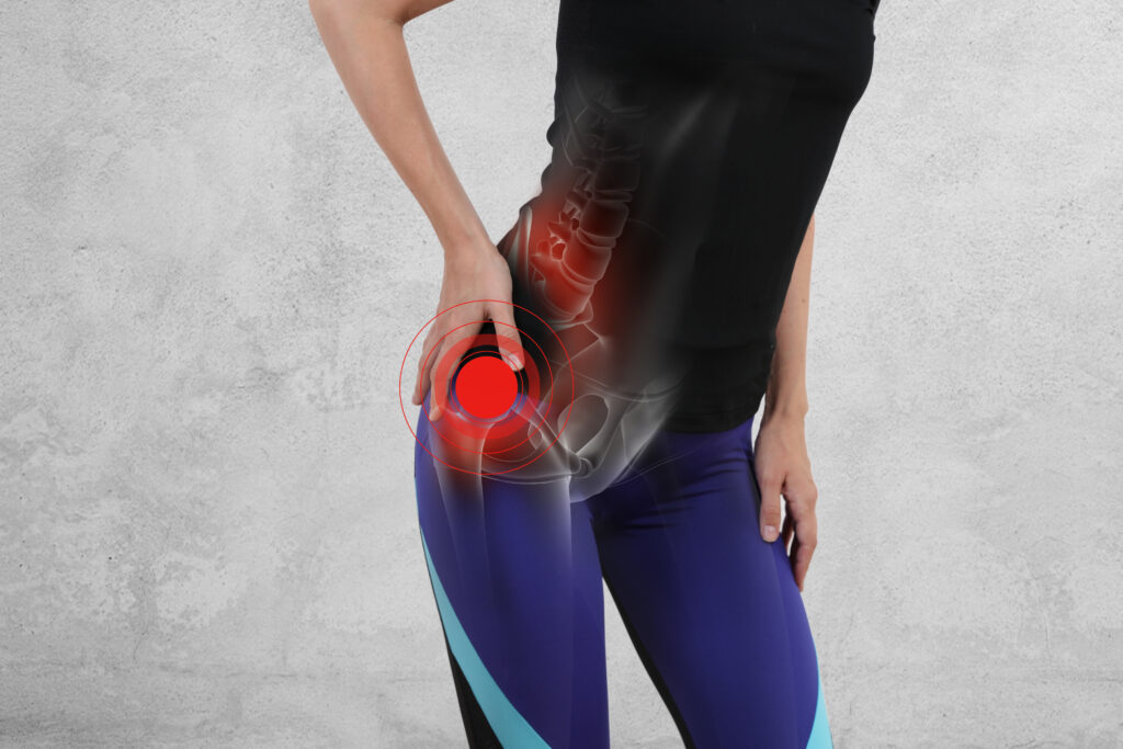 Woman with red dot on hip showing hip pain