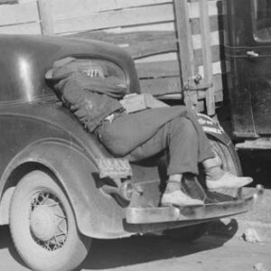 person sleeping on their car on their back